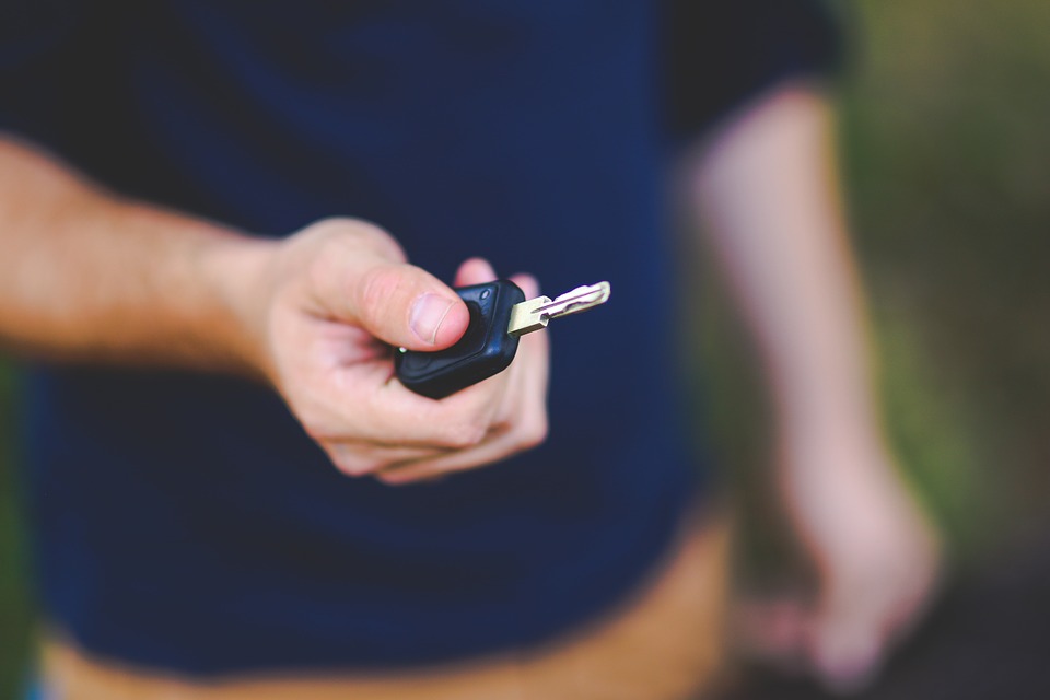 Person holding a car key