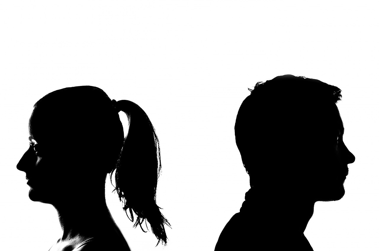 Silhouettes of two people facing away from each other